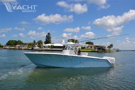 SeaHunter 33 - 2018 SeaHunter 33 boat cruising on a sunny day near waterfront homes.