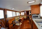 Grand Banks 42 Classic - Interior of 1985 Grand Banks 42 Classic yacht with wood furnishings and cozy seating area.