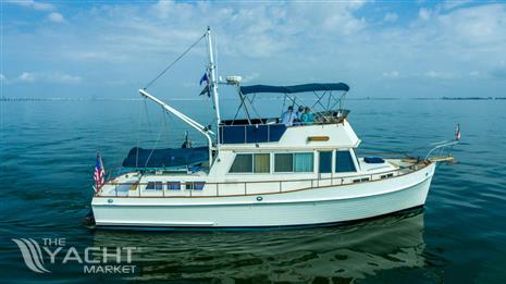 Grand Banks 42 Classic - 1985 Grand Banks 42 Classic yacht cruising on calm waters under a blue sky.