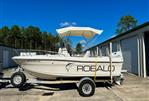 Robalo 1820 Center Console - 1994 Robalo 1820 Center Console boat on trailer, parked outdoors under clear blue sky.