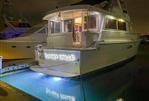 Hatteras 62 Cockpit Motor Yatch - 1990 Hatteras 62 Cockpit Motor Yacht docked at night with illuminated name "Sunset Grille".