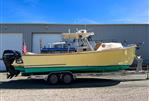 Padebco V27 Center Console - 2003 Padebco V27 Center Console boat on trailer, parked outside a warehouse.