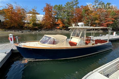 Hinckley Talaria 29C - 2013 Hinckley Talaria 29C boat docked by autumn trees.