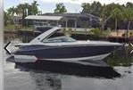 Monterey 328SS - 2015 Monterey 328SS boat on calm water near a residential dock.