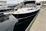 Blackfin 29 Combi - 1992 Blackfin 29 Combi boat docked at marina, sleek design, calm water.