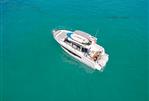 Jeanneau NC 895 S2 - 2025 Jeanneau NC 895 S2 boat on clear turquoise water, aerial view.