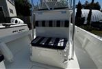 Eastern 248 Center Console - 2021 Eastern 248 Center Console boat with striped seating, docked outdoors.