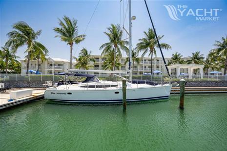 Hunter 50ac - Hunter 50ac 2010 sailboat named The Journey docked at a marina with palm trees.