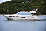 Prestige 550 - Luxury 2014 Prestige 550 yacht cruising on a serene lake with lush green backdrop.