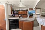 Sea Ray 340 Sundancer - Interior of 2002 Sea Ray 340 Sundancer yacht with kitchenette and cozy sleeping area.