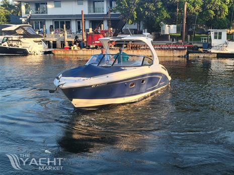 Chaparral 327 SSX - 2013 Chaparral 327 SSX boat cruising in a marina.