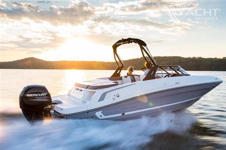 Bayliner VR5 - 2024 Bayliner VR5 boat cruising on a lake at sunset.