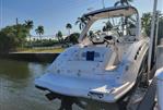 Chaparral 327 SSX - 2013 Chaparral 327 SSX boat docked by a tropical waterfront.