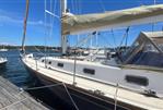 Tartan 4100 - 2003 Tartan 4100 sailboat docked at marina under clear blue sky.