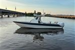 Custom Leblanc CC - 2003 Custom Leblanc CC boat on calm water near a bridge at sunset.