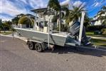 Pathfinder 2500 Hybrid - 2019 Pathfinder 2500 Hybrid boat on trailer, parked on sunny street.