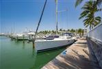 Hunter 50ac - Hunter 50ac 2010 sailboat docked at a marina with palm trees and clear blue sky.