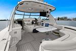 Sea Ray 500 Sundancer - 2005 Sea Ray 500 Sundancer yacht interior with seating and table, docked by waterfront.