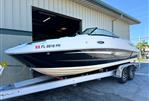 Sea Ray 260 Sundeck - 2014 Sea Ray 260 Sundeck boat on trailer outside dealership.