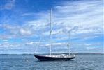 Hinckley Bermuda - 1967 Hinckley Bermuda sailboat on calm sea under blue sky.