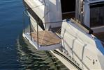 Jeanneau Leader 10.5 S2 - 2025 Jeanneau Leader 10.5 S2 yacht with extended swim platform on calm water.