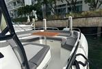 Jeanneau Leader 9.0 CC - 2023 Jeanneau Leader 9.0 CC boat with spacious seating and table, docked by waterfront.