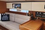 Grand Soleil 47 - Interior of 2015 Grand Soleil 47 yacht with beige sofa and navigation equipment.