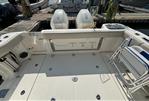 Boston Whaler 325 Conquest Pilothouse - 2020 Boston Whaler 325 Conquest Pilothouse boat deck with twin engines at dock.