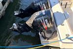 Pursuit 2800 Open - 1992 Pursuit 2800 Open with twin Suzuki outboard motors docked in water.