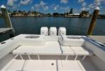 SeaHunter 33 - 2018 SeaHunter 33 boat with triple engines, docked by a scenic waterfront.