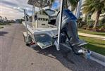 Pathfinder 2500 Hybrid - 2019 Pathfinder 2500 Hybrid boat with Yamaha engine on a sunny street.