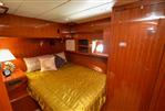 Hampton 580 Pilot House - Luxurious bedroom interior of 2009 Hampton 580 Pilot House yacht with wooden finish.