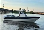 Custom Leblanc CC - 2003 Custom Leblanc CC boat on calm water near a bridge.