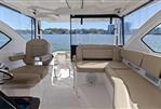 Pursuit OS 355 Offshore - Interior of 2018 Pursuit OS 355 Offshore boat with beige seating and water view.