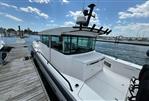 Axopar 37 XC - 2020 Axopar 37 XC boat docked at a marina on a sunny day.