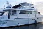 Hatteras 62 Cockpit Motor Yatch - 1990 Hatteras 62 Cockpit Motor Yacht docked at marina, side view.