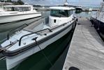 Axopar 28 CABIN - 2019 Axopar 28 CABIN boat docked at marina, featuring sleek design and modern cabin.