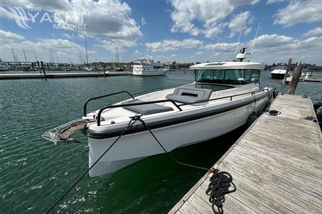 Axopar 37 XC - 2020 Axopar 37 XC boat docked at a marina on a sunny day.