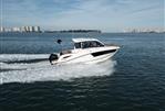 Bayliner T25 EXPLORER - 2024 Bayliner T25 EXPLORER cruising on open water, cityscape in background.