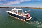 MJM 36z Downeast - 2015 MJM 36z Downeast boat cruising on calm waters with American flag.