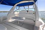 Sea Ray 340 Sundancer - 2002 Sea Ray 340 Sundancer boat interior with white seating and blue canopy.