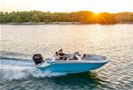 Bayliner M17 - 2024 Bayliner M17 boat cruising at sunset on a serene lake.