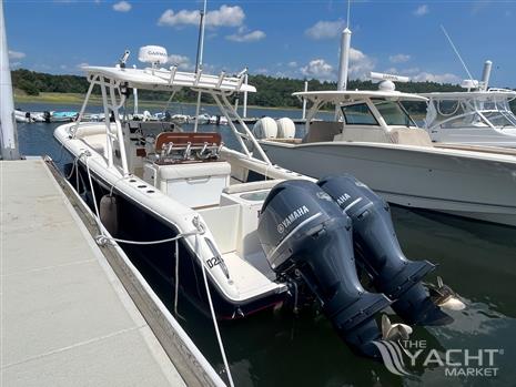 Pursuit S 280 Sport - 2011 Pursuit S 280 Sport boat docked with twin Yamaha engines.