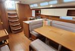 Grand Soleil 47 - Interior of 2015 Grand Soleil 47 sailboat with modern wood finish and cozy seating area.