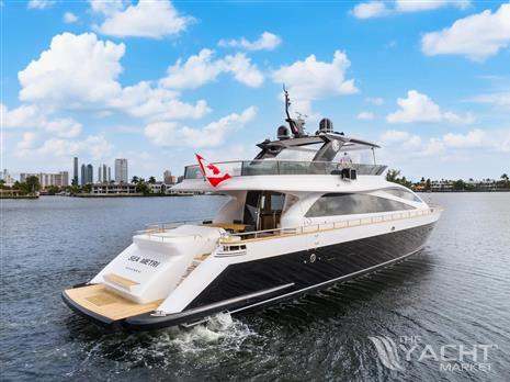 Amer 94 - Luxurious 2017 Amer 94 yacht cruising on a sunny day with city skyline backdrop.