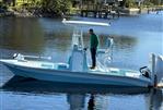 Shallow Sport 24 Mod V - 2021 Shallow Sport 24 Mod V boat on calm water with a person standing.