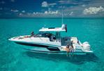 Jeanneau Leader 12.5 - 2024 Jeanneau Leader 12.5 yacht on clear turquoise water, people relaxing onboard.