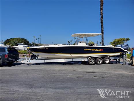 Marlago FS 35 - 2008 Marlago FS 35 boat on trailer, parked near palm trees and a GMC vehicle.