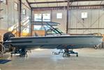 Axopar 28 T-Top - 2023 Axopar 28 T-Top boat in a spacious indoor storage facility.