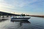 Custom Leblanc CC - Custom 2003 Leblanc CC boat on calm water near a bridge at sunset.